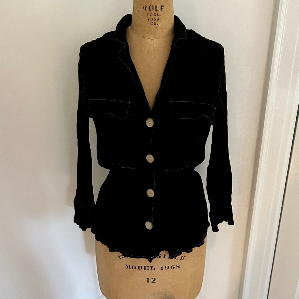 Black Zara top modeled after Issey Miyake's Pleats Please fabric